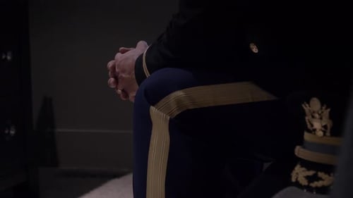 Man in Military Uniform Sits Calmly