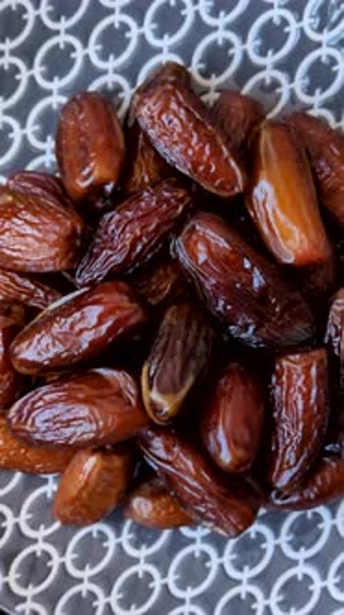 Dried dates on a ceramic plate for Ramadan or Iftar. Dates fruit as a background