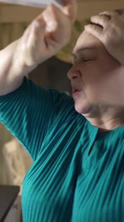 Woman with Headache Taking Medication and Drinking Water