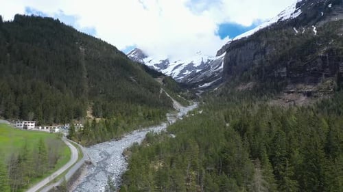 Drone flight over a beautiful alpine glacier valley and vast mountainous landscape. Kandersteg, Swit