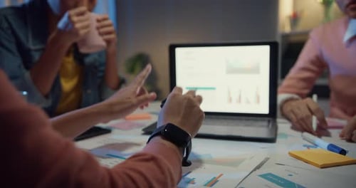 Team Analyzes Data in Modern Urban Office at Night