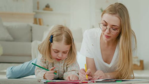 Woman and Child Drawing Together in Home