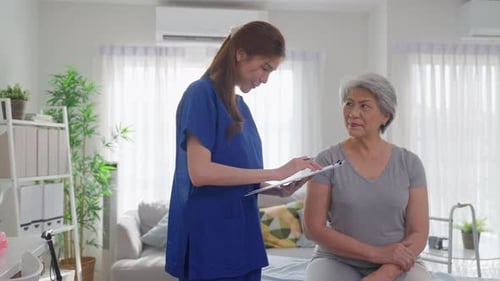 Asian beautiful caregiver examine senior woman patient at nursing home.