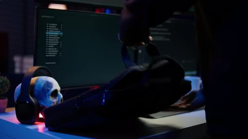 Cybercriminal Getting Notebook From Bag Starting Work on Malware Script