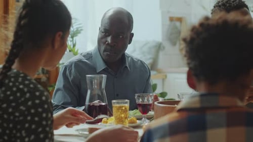 Family Gathering at a Table Sharing a Meal