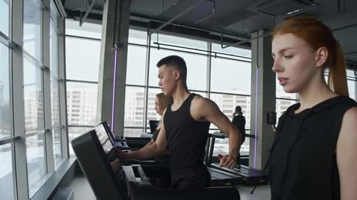 Young People Engage in Active Sports By Exercising on a Treadmill at the Gym