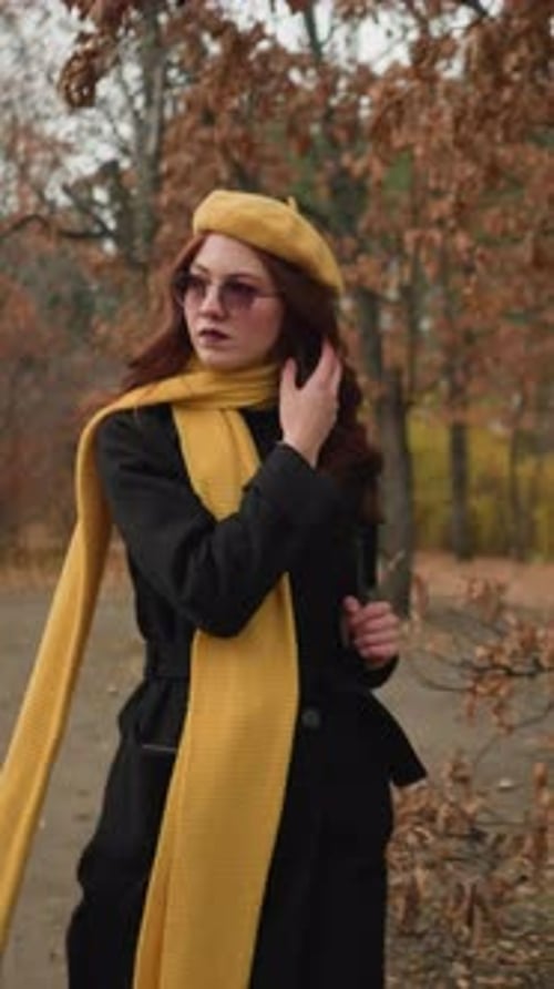 Focused Tourist in Yellow Adjusting Hair on Forest Walk