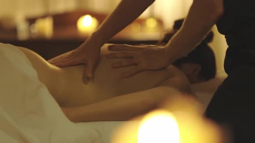 Woman Receiving Massage in Relaxing Setting