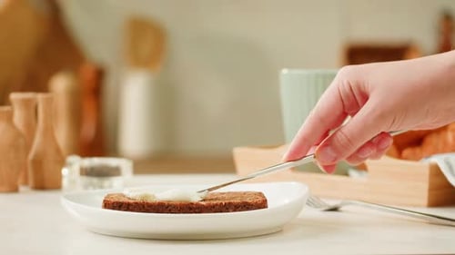 Spreading White Spread on Slice of Toasted Bread