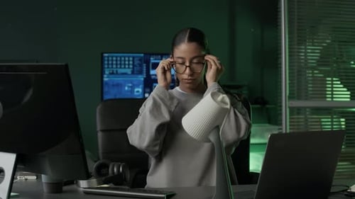 Young Female Programmer Getting Ready to Work on Computer in Office at Night