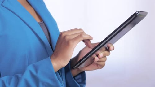 hand of black businesswoman using digital tablet in her office