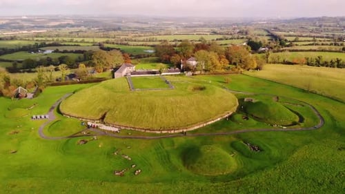 Knowth neolithic passage grave aerial tilt down shot. Historic monument located at Bru na Boinne, Ri
