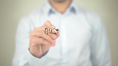 Business Essentials Man Writing on Transparent Screen