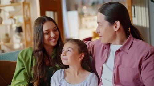 Home Family Watching Comedy on Sofa Embracing Together in Living Room Closeup
