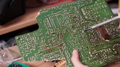 Soldering Electronic Components on Green Circuit Board
