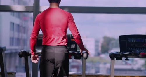 View From Behind Muscular Young Man Training at Gym Guy Runs on Treadmill Confident Bodybuilder