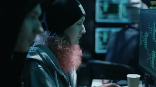 Young Adults Working at Computers in Dark Room