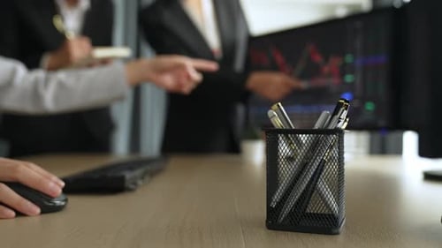 Businesswomen Analyzing Stock Market Data in Modern Office