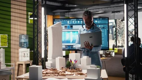 African American Male Developer Examines Detailed Construction Blueprints