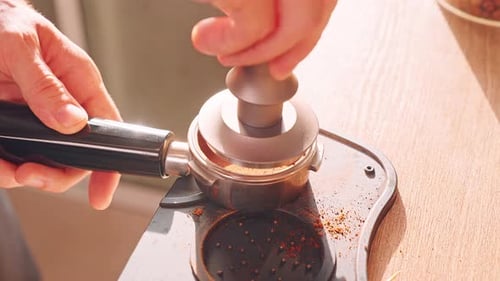 Man Tamping Coffee for Rich Espresso at Home