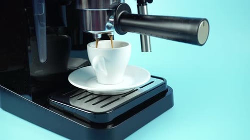 Espresso Pouring into Cup from Coffee Machine