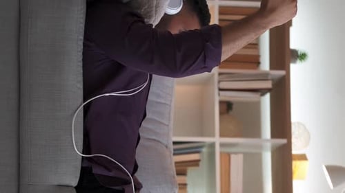 Young Adult Listening to Music at Home