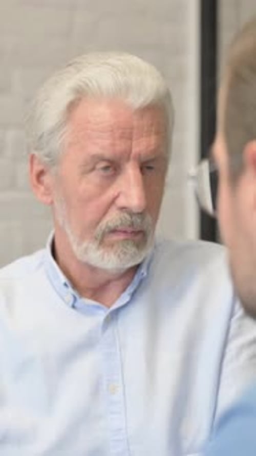 Close up of Old Businessman Talking with Employee in Office, vertical video