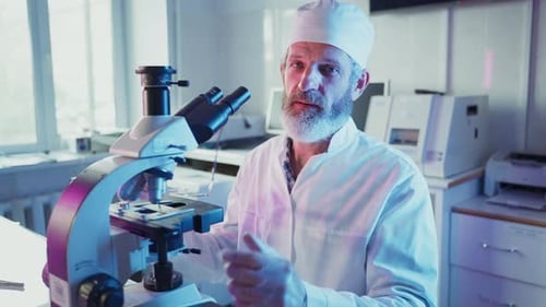 Scientist with Microscope in Bright Modern Laboratory