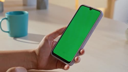 Hand Taps Green Screen on Cell Phone