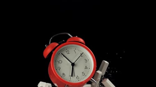 Alarm Clock and School Crayons Fly Up on a Black Background Filmed on a Highspeed Camera at 1000 Fps