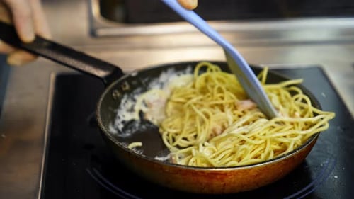 Spaghetti with Ham Cooking in Frying Pan