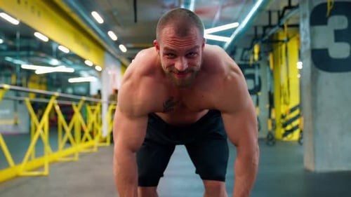 Bodybuilder Lifting Dumbbell In The Gym