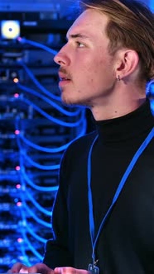 Young Adult Working in Blue Lit Server Room