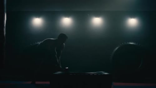 Muscular Adult Training in Dimly Lit Gym