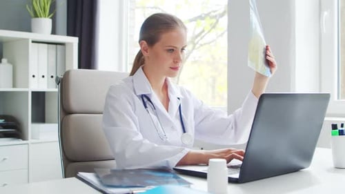 Doctor Works in the Medical Office Woman in White Coat Workplace of a Professional Female Therapist