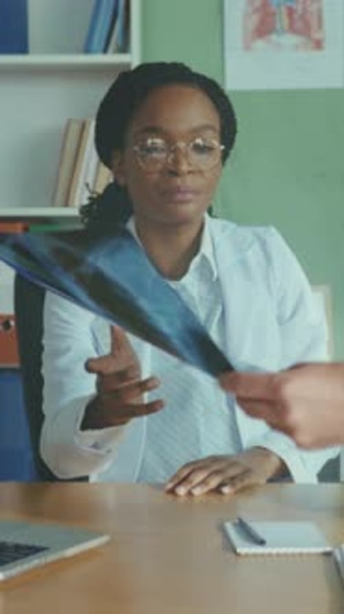 Medical Professional Calmly Analyzes Radiograph Details and Provides Comprehensive Next Step