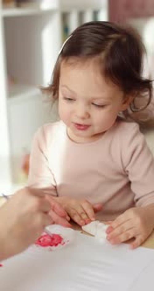 Child Painting Indoors with Cotton Balls