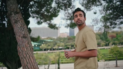 Carefree Guy Strolling Nature Park Holding Coffee Cup Closeup Italian Man Enjoy