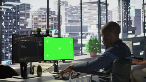 Man with Paraplegia Optimizing Company Software with Mockup Computer