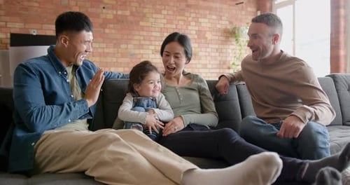 Family Relaxing Together on Sofa in Home