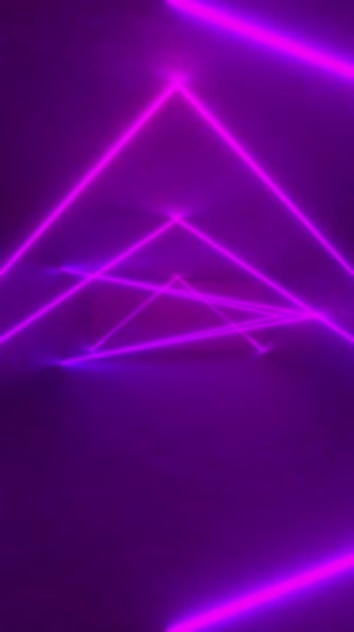 3D neon triangle glows on concrete floor