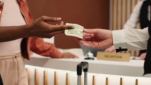 Handing Banknote to Bellboy Close Up