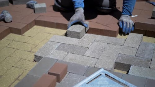 Worker Laying Pavers for Outdoor Space