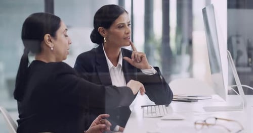4k video footage of two businesswomen working together on a computer in an office