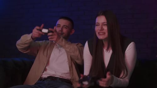 Enthusiastic Young Adults Playing Video Games at Home