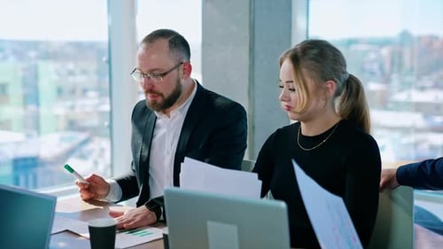 Business Meeting with Chart Presentation in Modern Office
