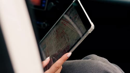 Woman Uses Tablet Map App in Car
