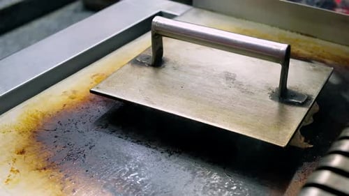 Person Cooking Wraps on Flat Grill