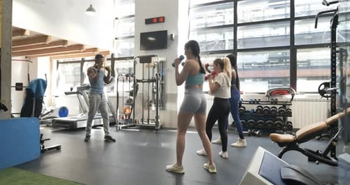 Instructor Giving a Fitboxing Class in a Gym