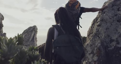Adventurous Couple Hiking to the Mountain Summit